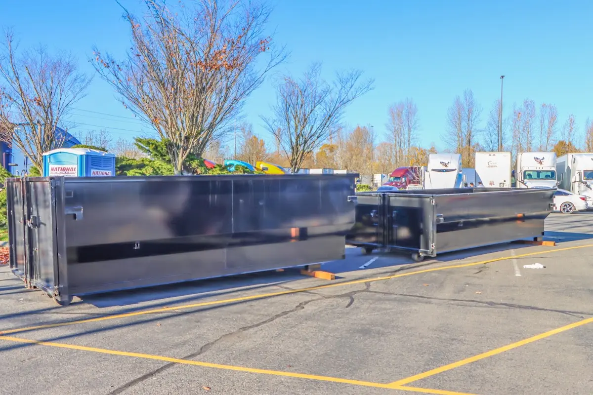 Professional dumpster rental service with roll-off container on residential driveway in Wahoo